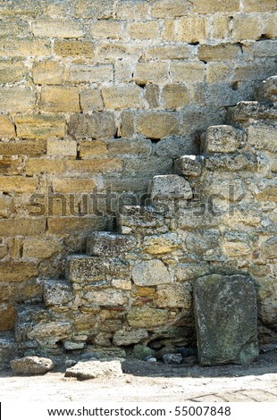 Old stone staircase. Ancient steps on the wall of the Exterior castle - side view.