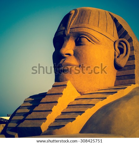 Egyptian sphinx - modern sandy sculpture in an old tradition of Egypt. Egyptian pharaon in art, travel in Africa.