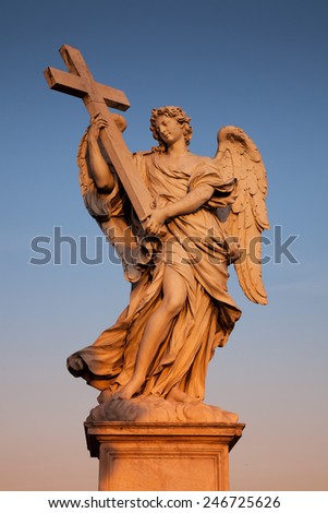 Bernini\'s angel at sunset along the Holy Angel bridge in Rome, Italy