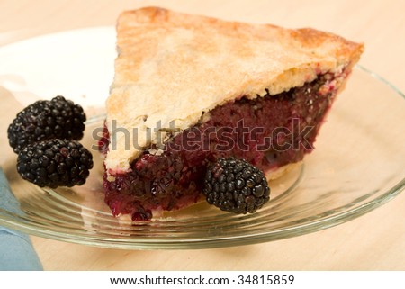 Blackberry pie fresh from the oven accompanied by ripe blackberry fruit