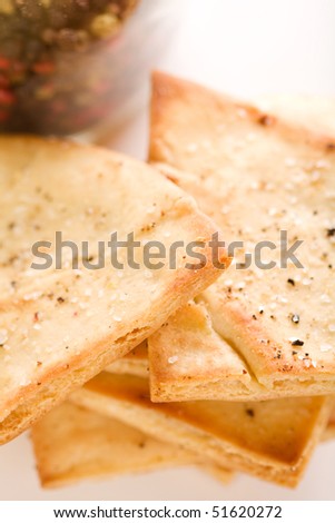 Garlic pita chips with large grain kosher salt and cracked pepper