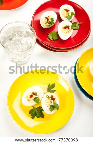 Holiday and party favorite deviled eggs on colorful plates
