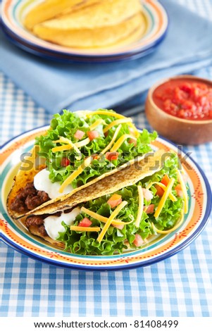Deluxe hard shelled beef tacos served with salsa