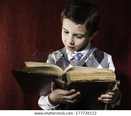 Child with red vintage book. Vintage clothes