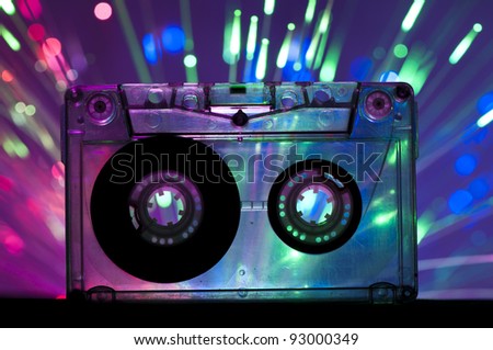Transparent Cassette tape and blue pink color disco light background