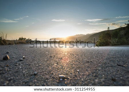 Mediterranean road on sunset. Cloudy sky