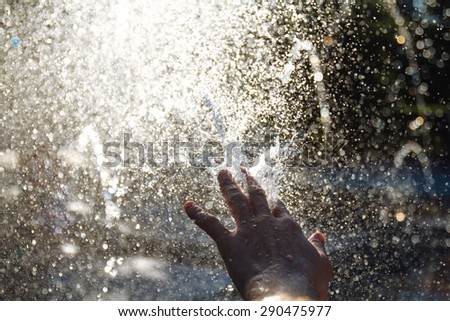 hand and a jet of water