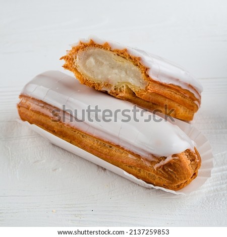 Traditional french eclairs filled with vanilla cream and powdered sugar, eclair with white filling ストックフォト © 