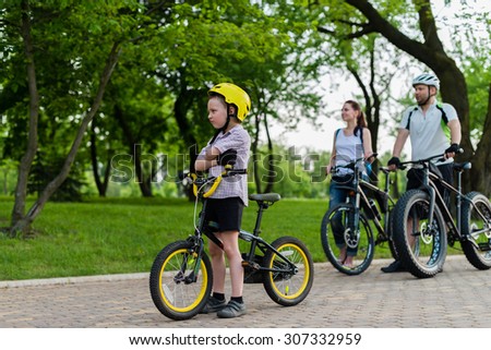 5 year old boy sitting on his bike in front of his family