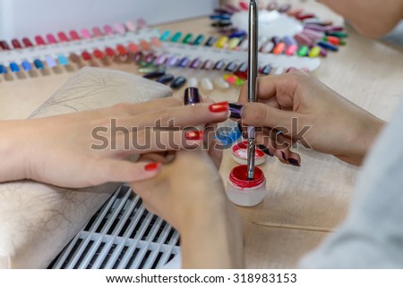 painting nails in nail salon, UV lap of quick dry nail polish manicure, focus on brush