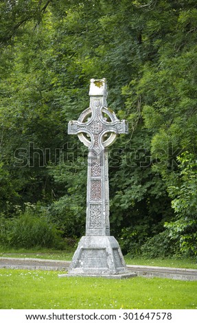 Lonely celtic cross monument with intricate celtic design found in a remote churchyard in county kerry in Ireland