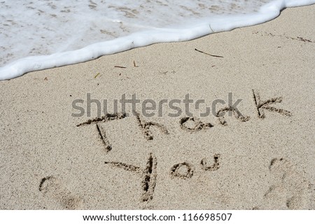 Concept or conceptual Thanksgiving day holiday text handwritten in sand on an exotic beach as metaphor to America,american,tradition,gratitude,message,celebration,greeting,traditional made in vacation
