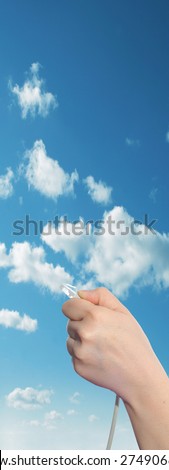 Conceptual human or man hand holding a internet or data cable in clouds over the blue sky background