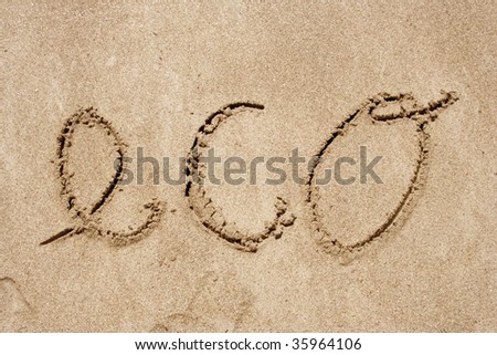 The word eco handwritten in sand on a beach, ideal for nature, conceptual or environmental designs