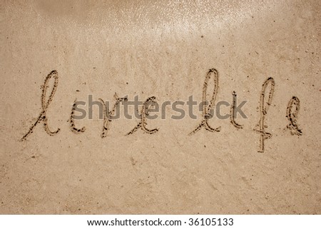 Live life handwritten in sand for natural, symbol,tourism or conceptual designs