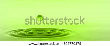 Concept or conceptual green liquid drop falling in water with ripples and waves background banner  metaphor to nature, natural, summer, spa, drink, cool, business, environment, rain or health design