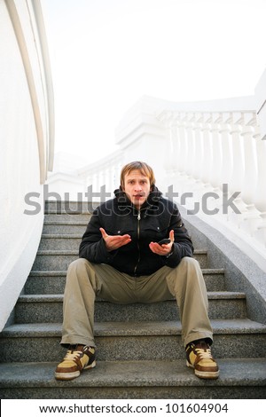 displeased man with phone. Bad connection. looking and question