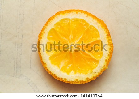 circle cutting orange segment lying on a table