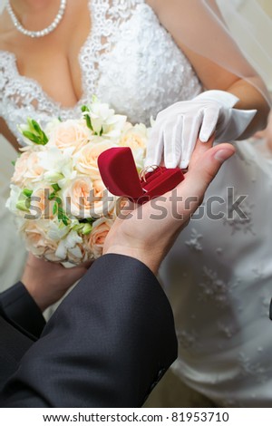 groom gives to bride a gold ring. Love in practice.