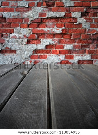 Old wooden  dark stage and an old brick wall, background