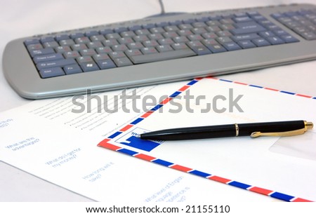 Paper, pen, and computer keyboard on the table