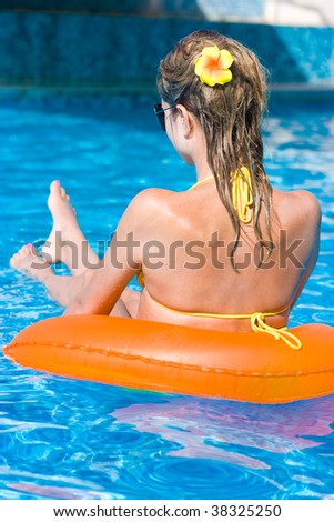 Beautiful blonde long-haired girl in swimming pool
