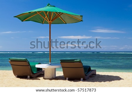 Two chairs and umbrella on the beach