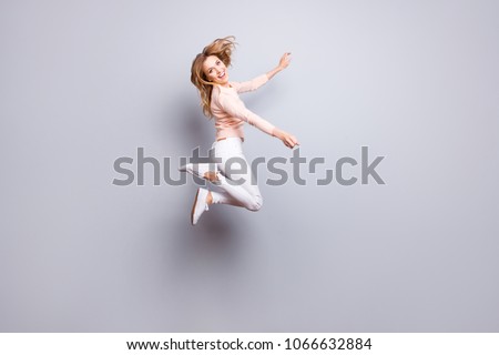 Image, Stock Photo Dreamy woman raising leg while standing near fence