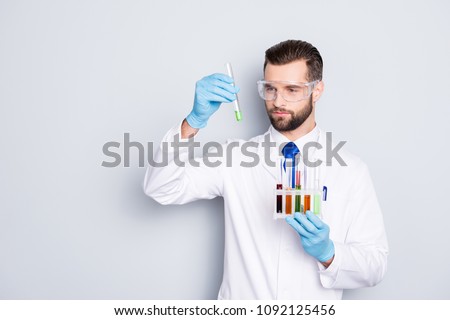 Image, Stock Photo Serious chemist examining liquid in flask in lab