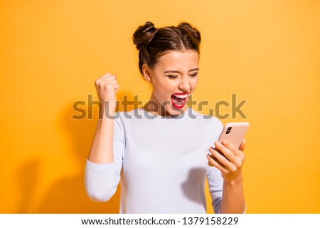 Portrait of delighted thrilled excited screaming lady impressed by news feed in her social network account rasing fists isolated on vibrant background in white clothing ストックフォト © 