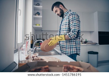 Profile side view portrait of his he nice attractive serious focused tired bearded guy wearing checked shirt doing domestic perfection in modern light white interior style kitchen indoors Stock foto © 