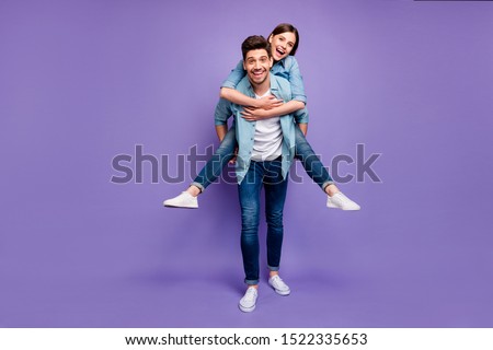 Full length photo of romantic funny funky married people have fun date hug piggyback  enjoy date wear stylish trendy clothes isolated over purple color background