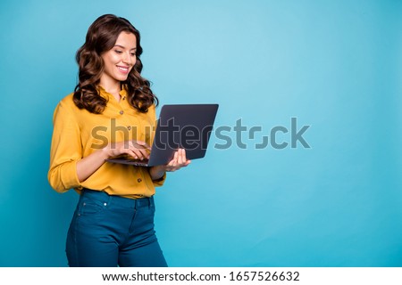 Portrait of her she nice attractive lovely cheerful cheery wavy-haired girl holding in hands laptop creating presentation isolated over bright vivid shine vibrant green blue turquoise color background
