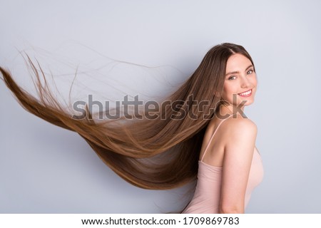 Close-up profile side view portrait of nice-looking attractive lovely gorgeous cheerful well-groomed brown-haired girl wind blowing silky smooth hair isolated on light gray pastel color background