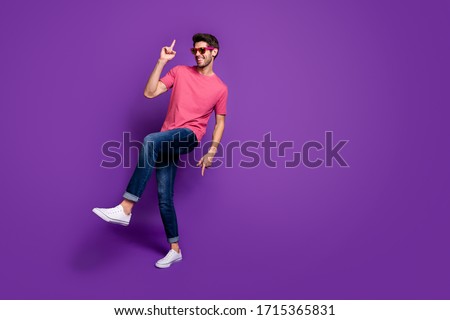 Full length photo of positive cheerful cool energetic guy music lover enjoy dance hip hop night club wear trendy clothes sneakers isolated over violet bright color background