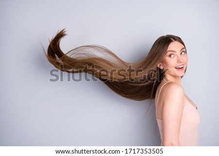 Close-up profile side view portrait of her she nice-looking attractive pretty cheerful well-groomed brown-haired girl wind blowing silky flawless hair isolated on light gray pastel color background