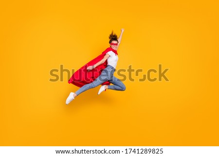 Full length body size view of her she nice attractive lovely strong powerful fit slim cheerful girl jumping wearing mantle flying fast isolated on bright vivid shine vibrant yellow color background Foto d'archivio © 