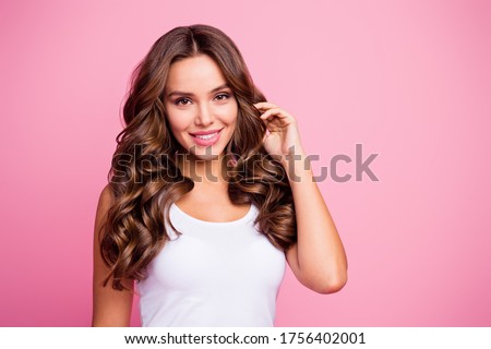 Close-up portrait of her she nice-looking attractive lovely lovable pretty cute winsome gorgeous cheerful cheery wavy-haired girl touching curls isolated over pink pastel color background