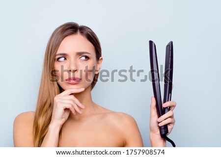 Close up photo portrait of cute pretty attractive brunette she her lady holding curl iron in hand can not decide use it or not isolated on grey background ストックフォト © 