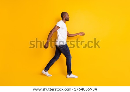 Similar – Dreamy modern man walking along city street