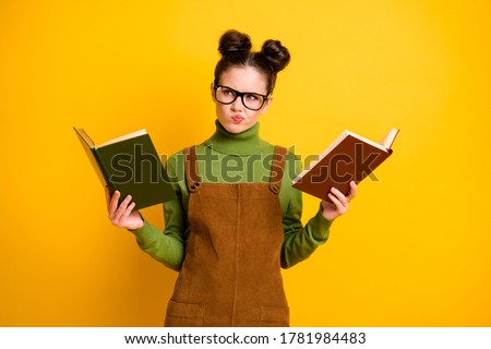 Portrait of her she nice attractive pensive minded knowledgeable girl nerd reading two book compare deciding solving exercise isolated bright vivid shine vibrant yellow color background Stock foto © 