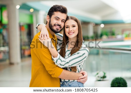 Portrait of his he her she nice attractive lovely charming tender sweet dreamy cheerful cheery couple dating meeting embracing in downtown building spending vacation