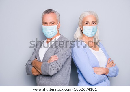 Similar – Image, Stock Photo Senior couple wearing protective face masks outdoors
