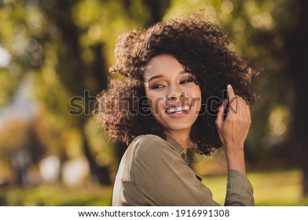 Similar – Image, Stock Photo Trendy ethnic model touching hair in projector light