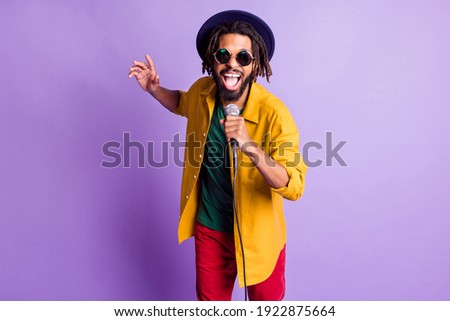 Portrait of crazy funny dark skin person open mouth sing have fun good mood isolated on purple color background