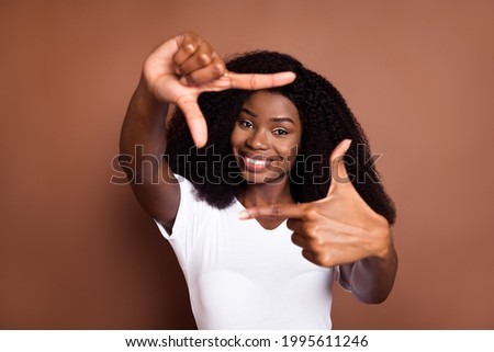 Similar – Image, Stock Photo Cheerful black showing frame gesture on city street