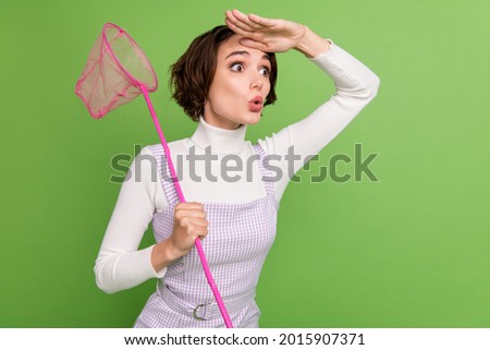 Profile side photo of young woman look forward ahead catch insect butterfly net isolated over green color background Stock foto © 