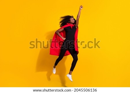 Full length photo of hooray super young lady jump wear black cloth cape isolated on yellow color background Foto d'archivio © 