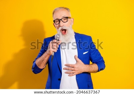 Similar – Image, Stock Photo Man holds a microphone in his hand ready to speak