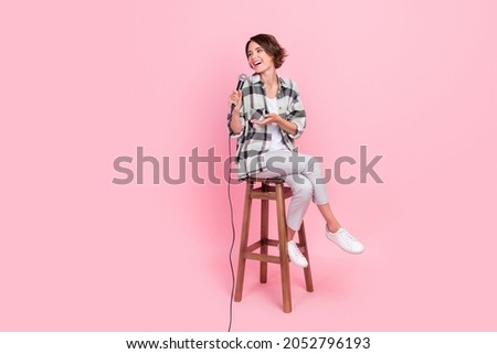 Full length photo of funky young brunette lady sit talk wear shirt trousers isolated on pink background Stockfoto © 